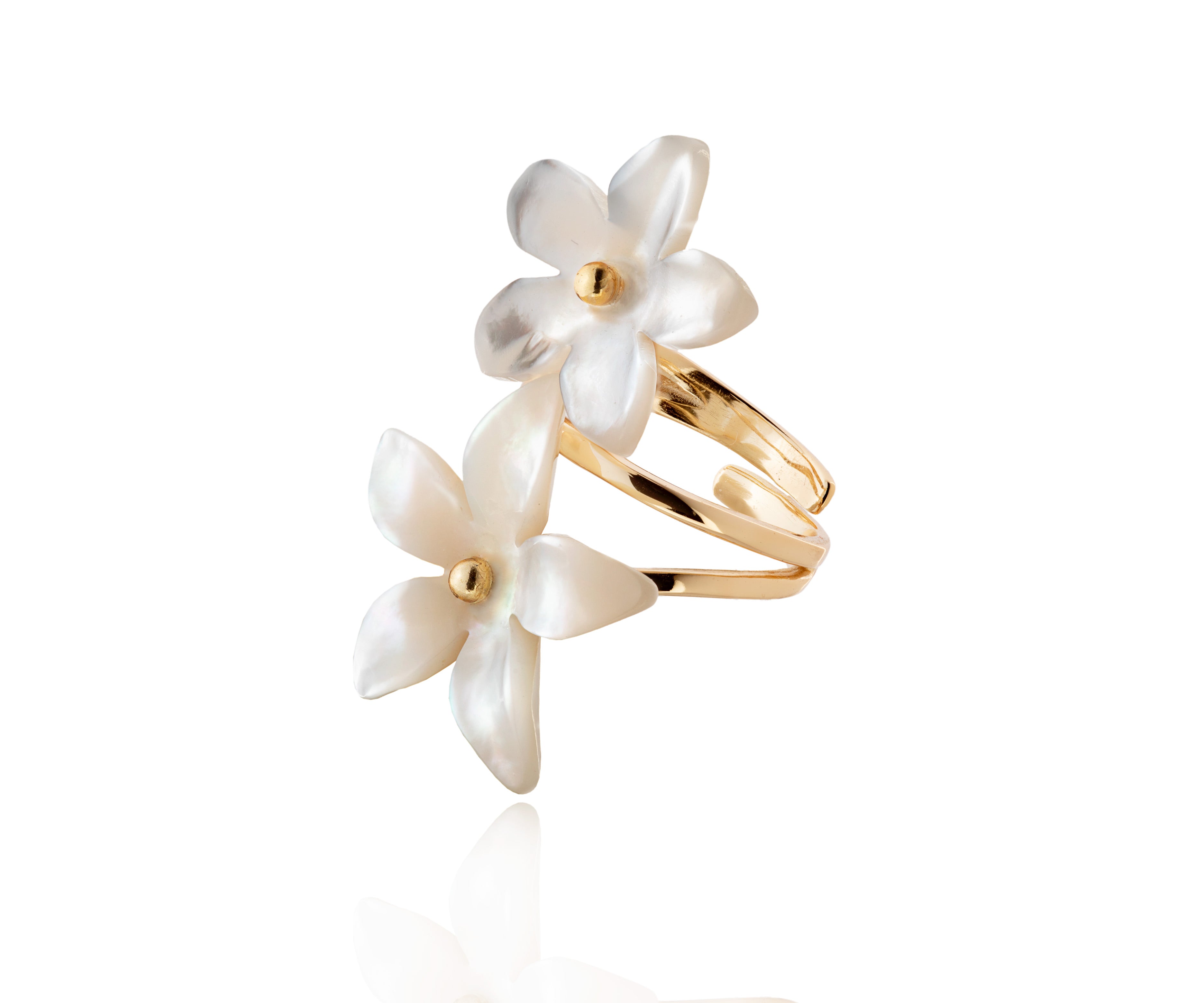 Anillo de flores de nácar sobre aro dorado.
